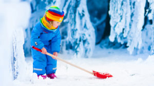 Kid shoveling snow to keep warm